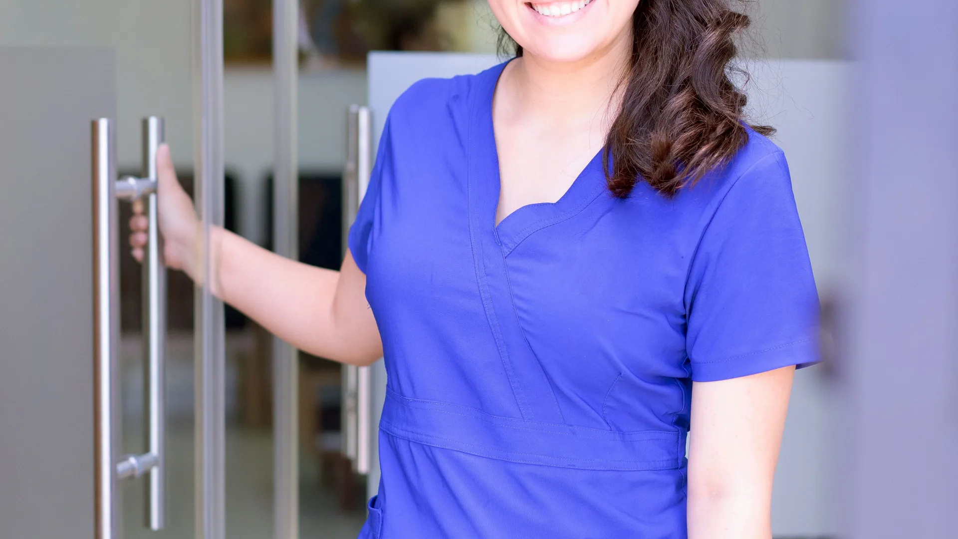 Clinical staff in blue scrubs on a multi-site medical uniform program