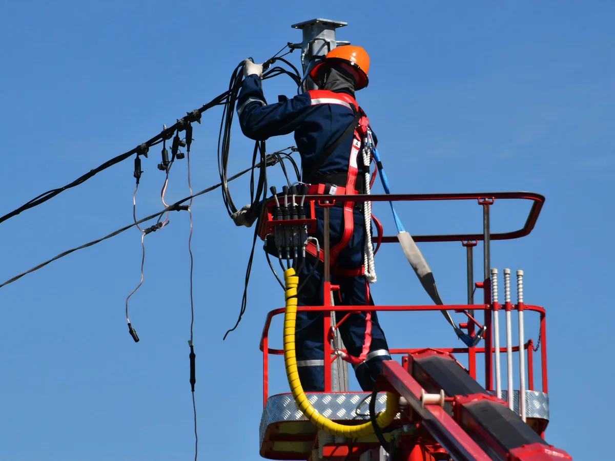 Utility line crew in hi-vis and flame-resistant workwear