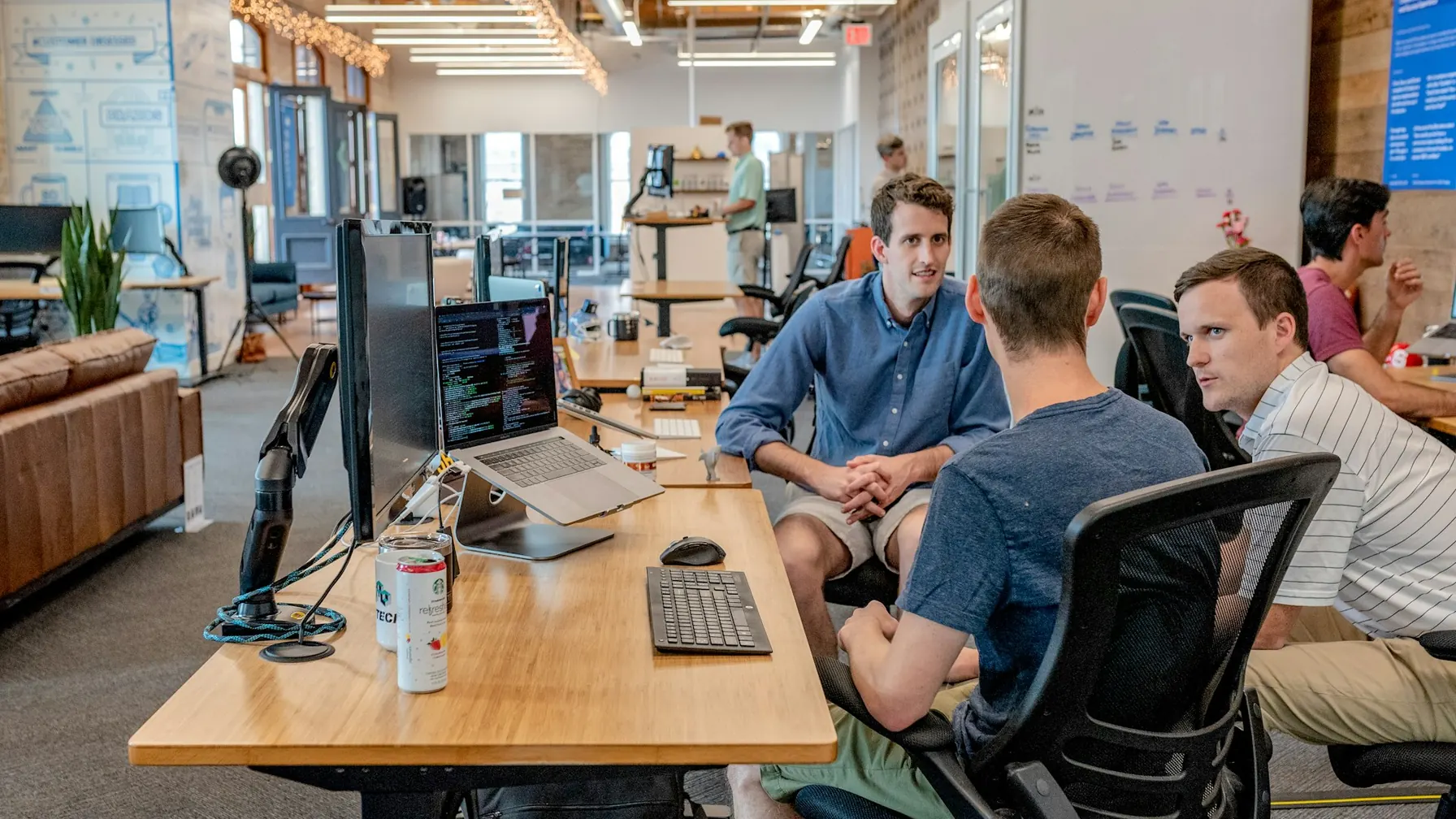 Corporate team in branded business wear working in a modern open-plan office
