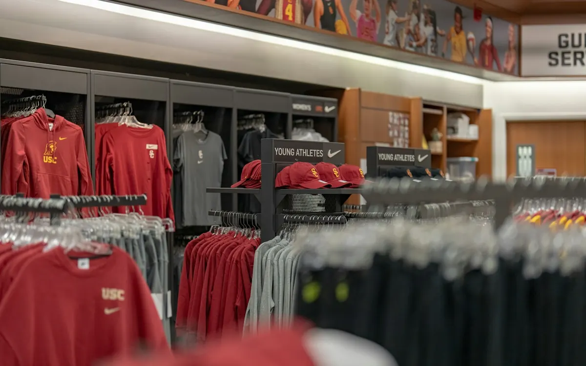 Branded corporate merchandise displayed on rails in a retail-brand store