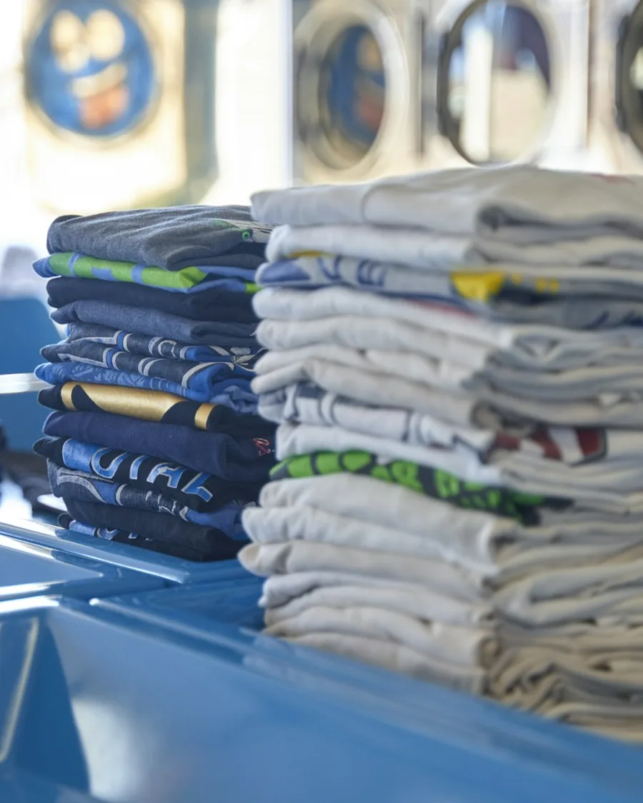 Folded corporate uniforms in a coordinated brand palette