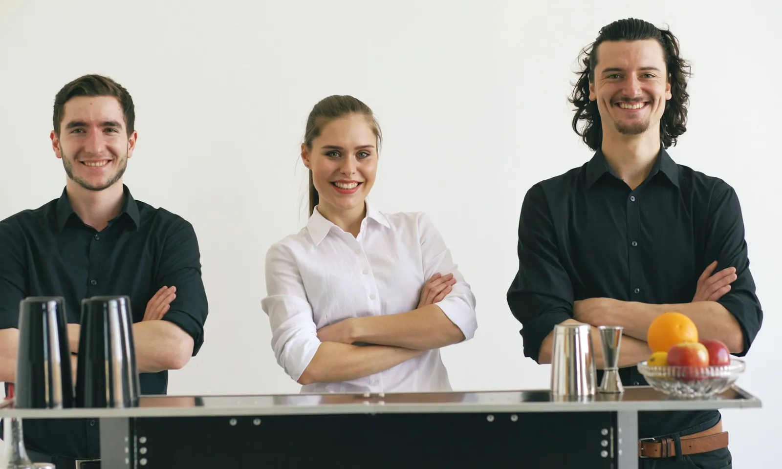 Hotel staff in coordinated hospitality uniforms across front-of-house and kitchen roles