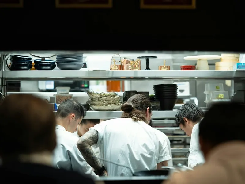 Kitchen brigade in chef jackets and kitchen trousers