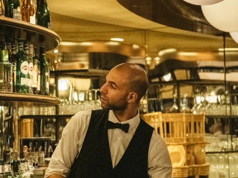 Restaurant waitstaff in coordinated server shirts and aprons